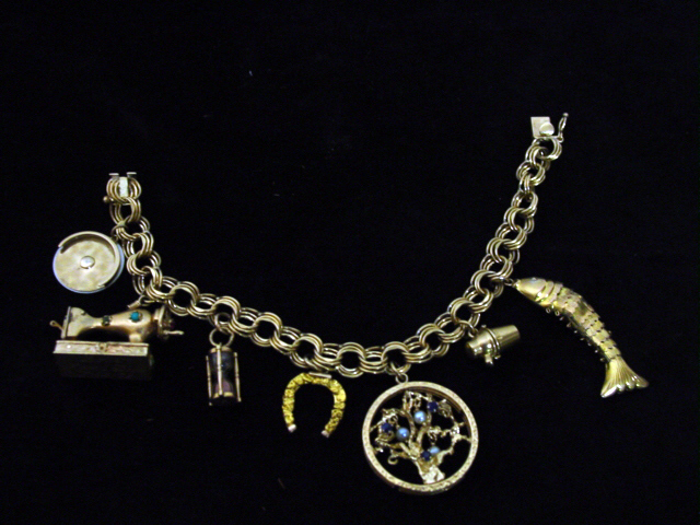 14kt Gold Charm bracelet w. fish.sewing machine etc.